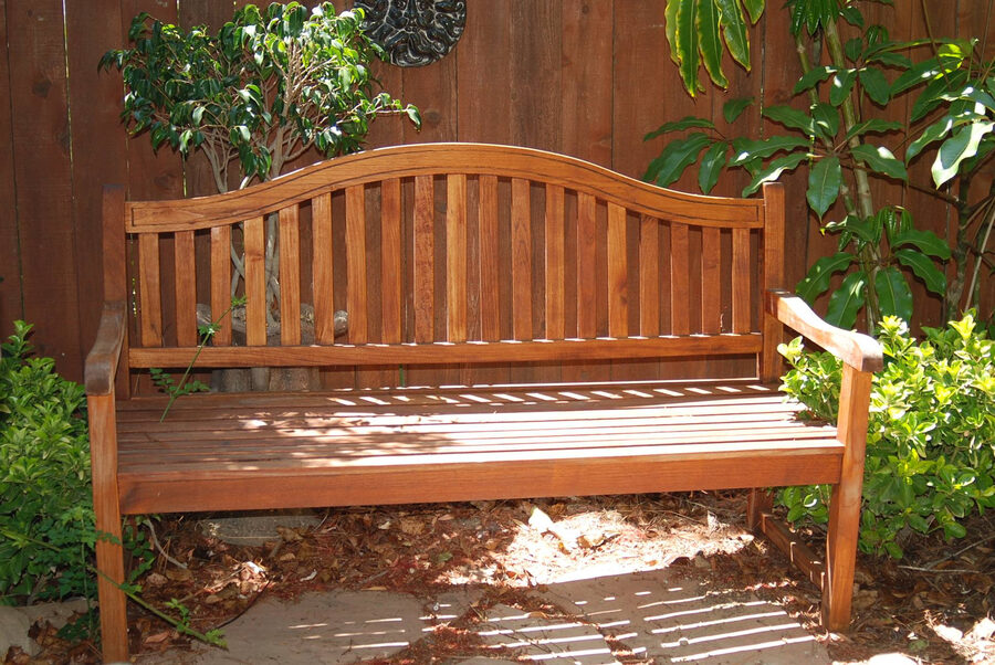 Refinished wooden garden bench with warm stain finish